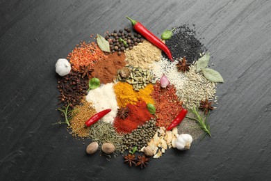 Photo of Different aromatic spices on grey table, top view
