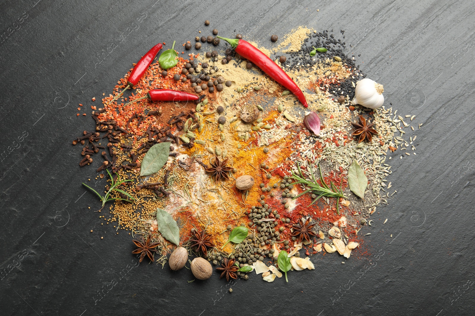 Different aromatic spices on grey table, top view Photo of Different aromatic spices on grey table, top view