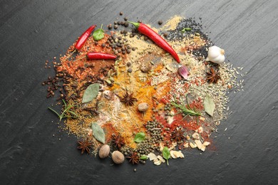 Photo of Different aromatic spices on grey table, top view