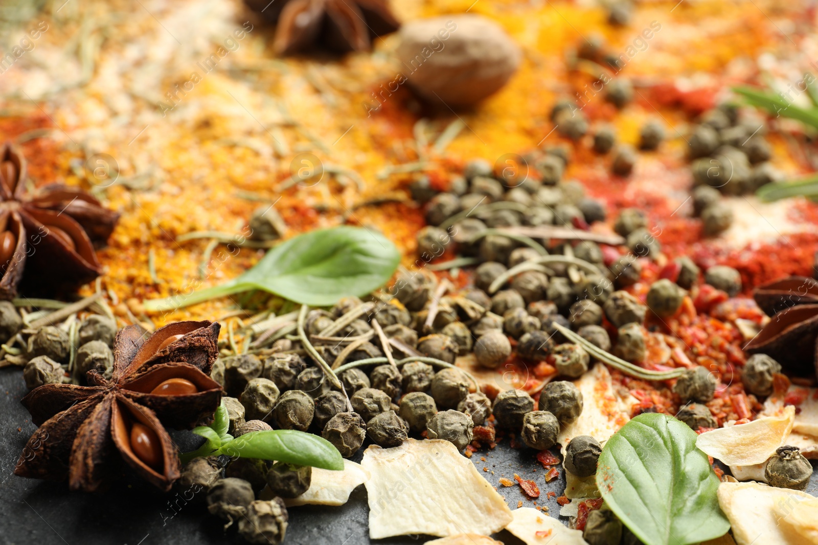 Different aromatic spices on grey table, closeup Photo of Different aromatic spices on grey table, closeup