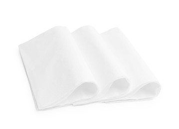 Photo of Folded disposable paper handkerchiefs isolated on white