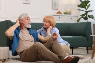 Photo of Lovely senior couple together on floor at home