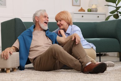 Photo of Lovely senior couple together on floor at home