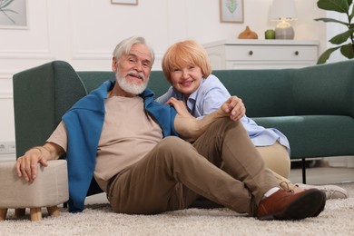 Photo of Lovely senior couple together on floor at home