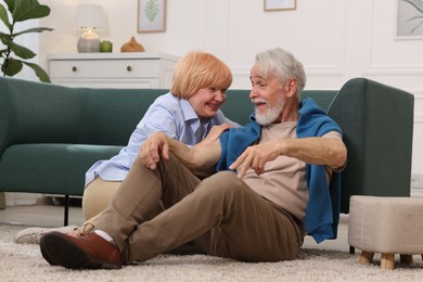 Photo of Lovely senior couple together on floor at home