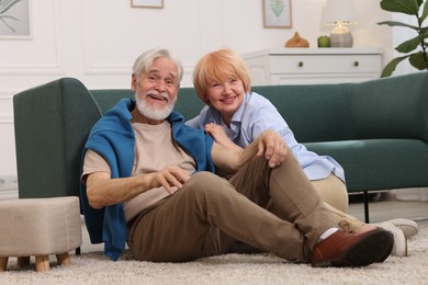 Photo of Lovely senior couple together on floor at home