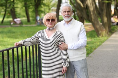 Photo of Lovely senior couple spending time together in park