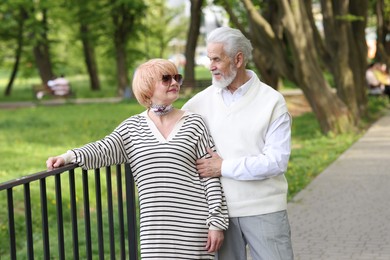 Photo of Lovely senior couple spending time together in park