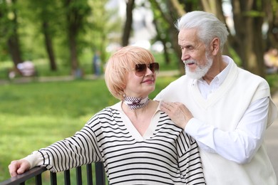 Photo of Lovely senior couple spending time together in park