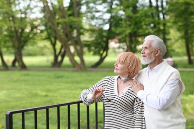 Photo of Lovely senior couple together in park, space for text