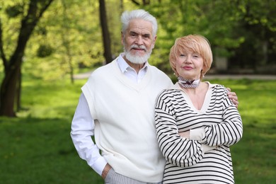 Photo of Lovely senior couple spending time together in park