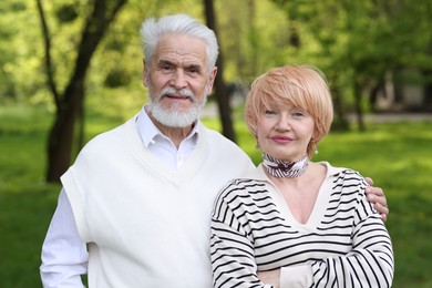 Photo of Lovely senior couple spending time together in park