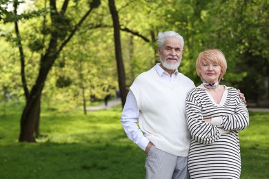 Photo of Lovely senior couple together in park, space for text
