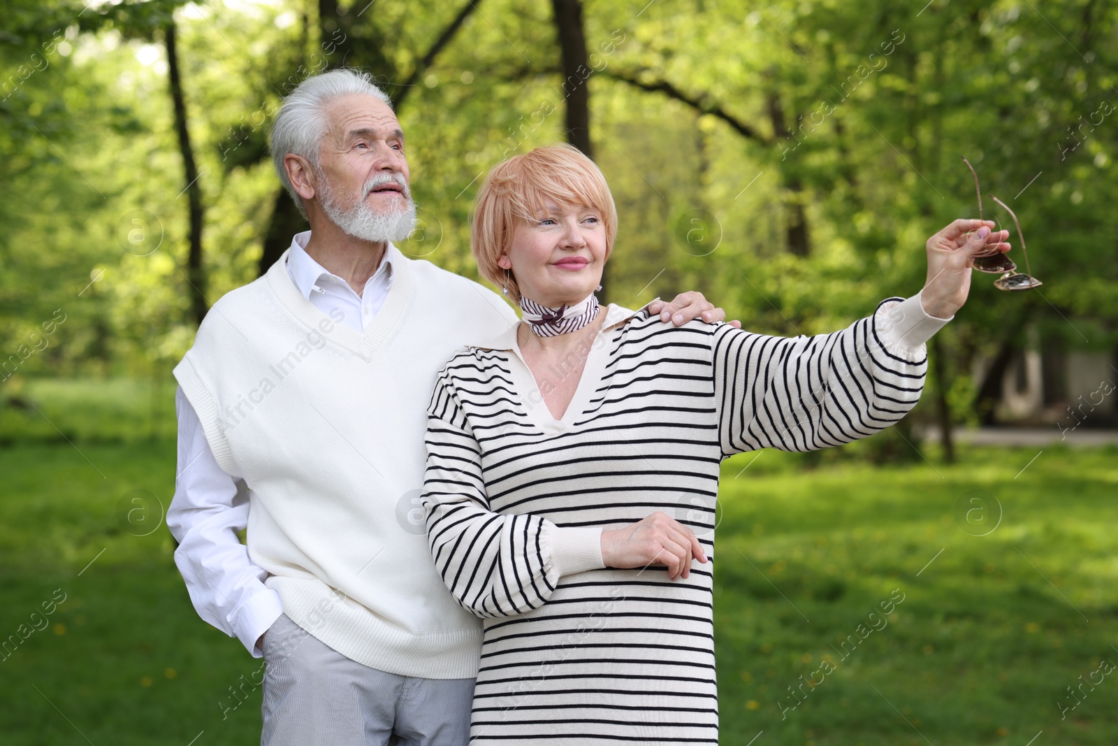 Lovely senior couple spending time together in park Photo of Lovely senior couple spending time together in park