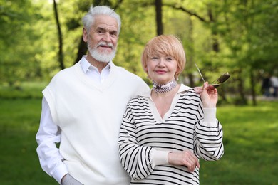 Photo of Lovely senior couple spending time together in park