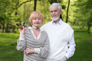 Photo of Lovely senior couple spending time together in park