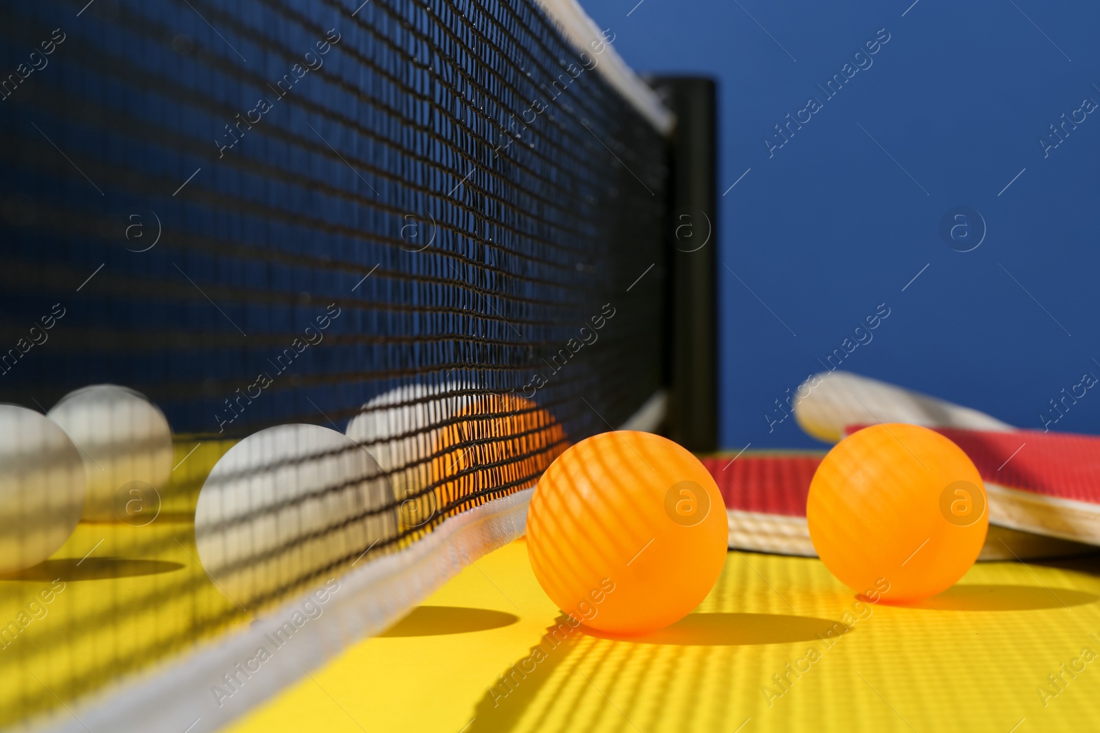 Ping pong balls on yellow table, closeup Photo of Ping pong balls on yellow table, closeup