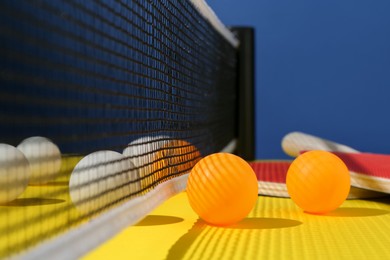 Photo of Ping pong balls on yellow table, closeup
