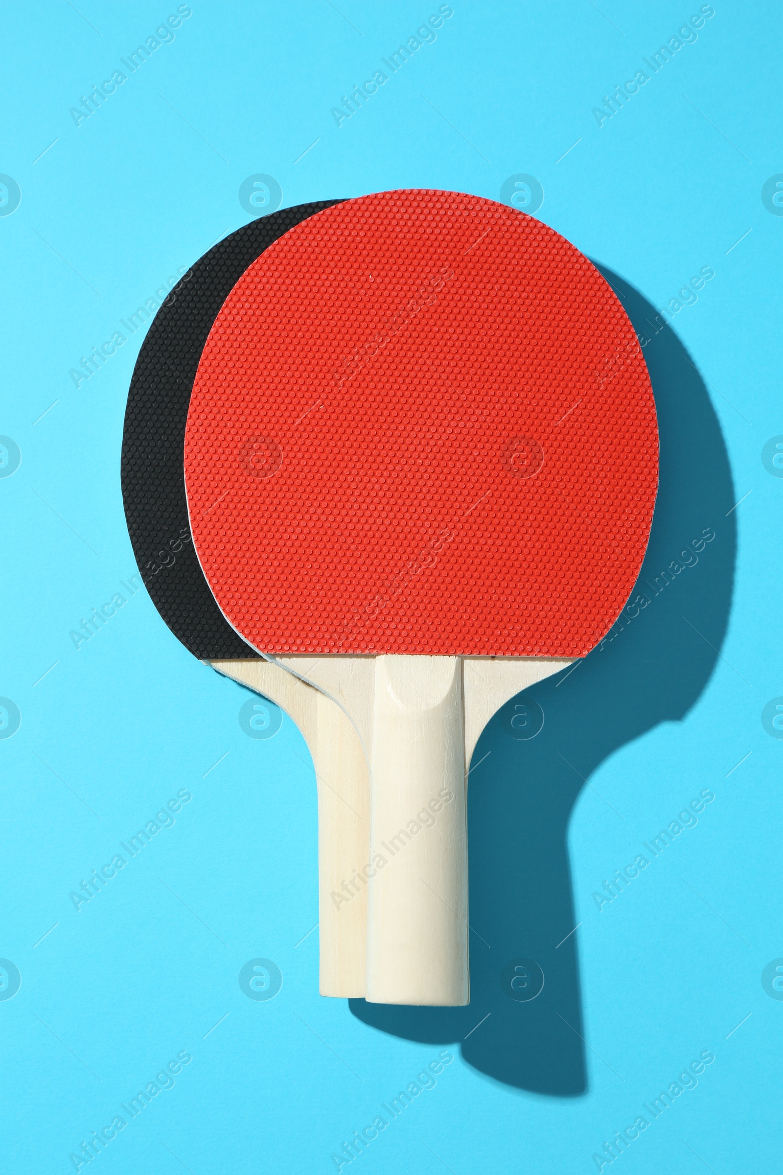 Ping pong rackets on blue background, top view Photo of Ping pong rackets on blue background, top view