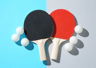 Photo of Ping pong rackets and balls on color background, flat lay