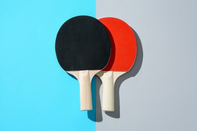 Photo of Ping pong rackets on color background, top view