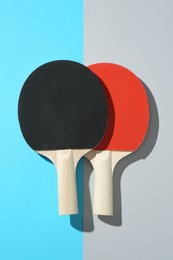 Photo of Ping pong rackets on color background, top view