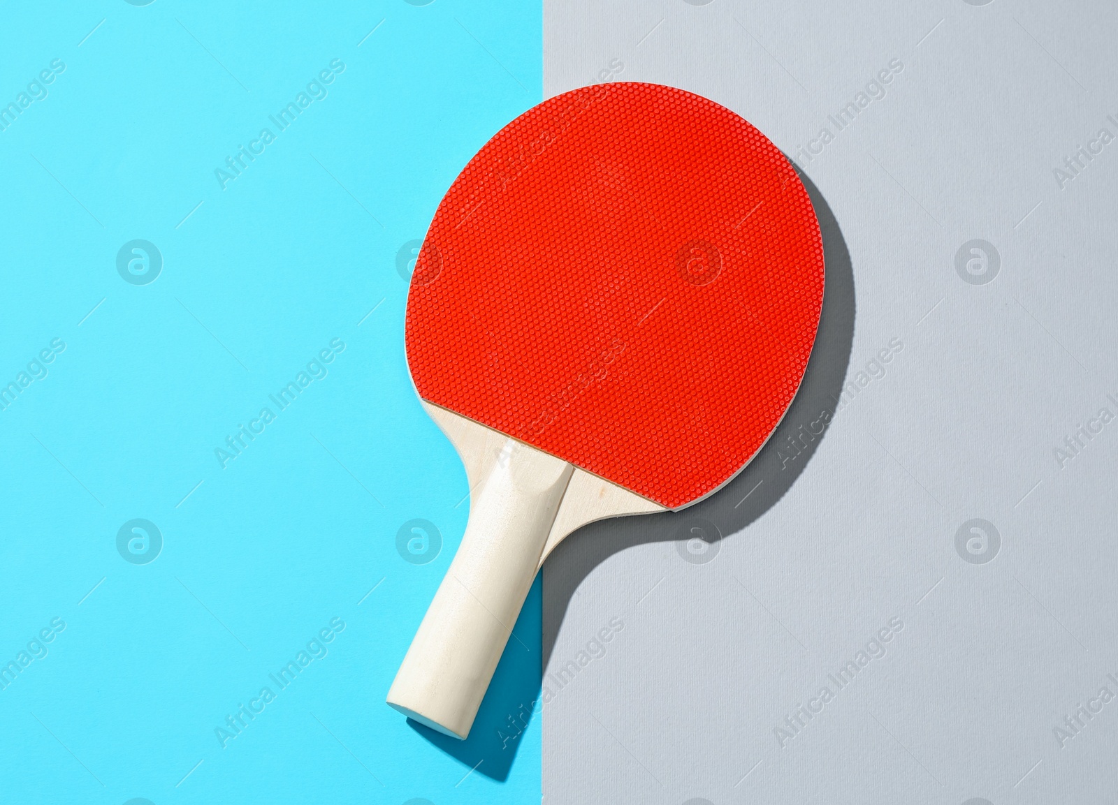One ping pong racket on color background, top view Photo of One ping pong racket on color background, top view
