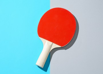 Photo of One ping pong racket on color background, top view
