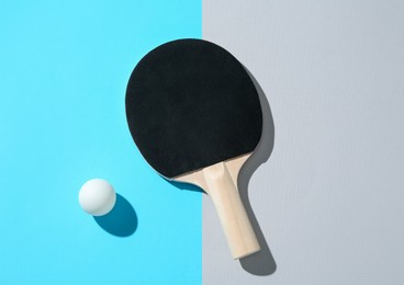 Photo of Ping pong racket and ball on color background, top view