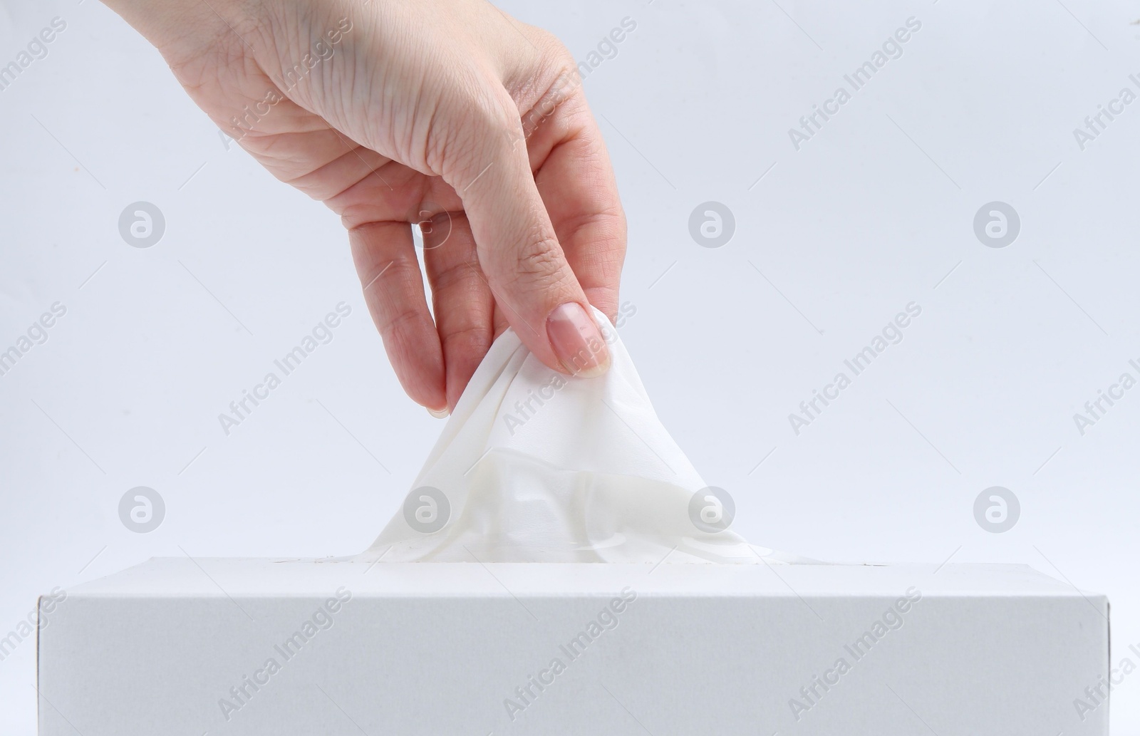 Woman taking handkerchief out of box on white background, closeup Photo of Woman taking handkerchief out of box on white background, closeup