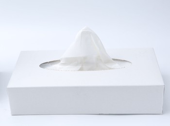 Photo of Box with paper handkerchiefs on white background