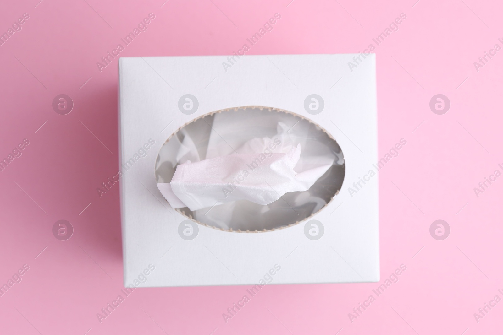 Box with paper handkerchiefs on pink background, top view Photo of Box with paper handkerchiefs on pink background, top view