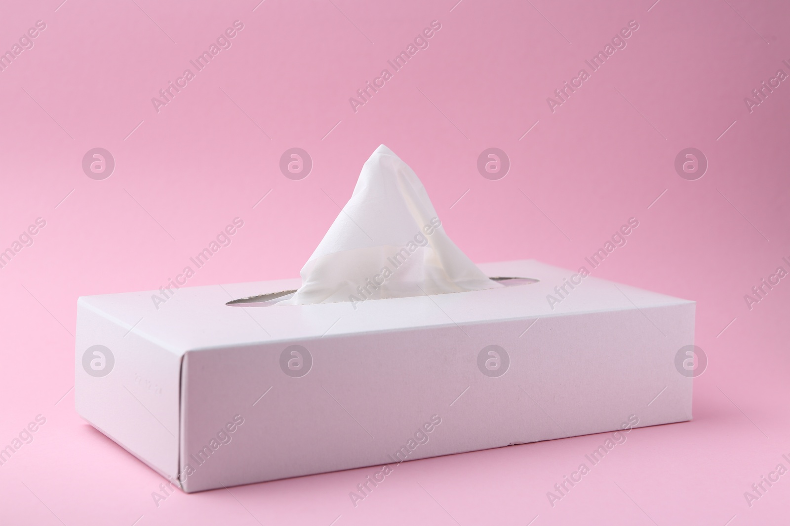 Box with paper handkerchiefs on pink background, closeup Photo of Box with paper handkerchiefs on pink background, closeup