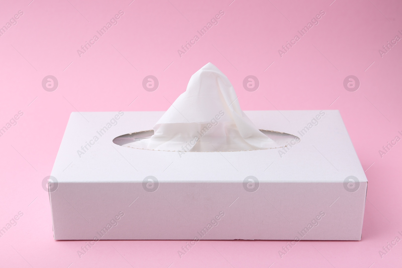 Box with paper handkerchiefs on pink background, closeup Photo of Box with paper handkerchiefs on pink background, closeup