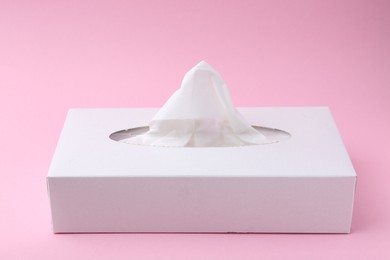 Photo of Box with paper handkerchiefs on pink background, closeup