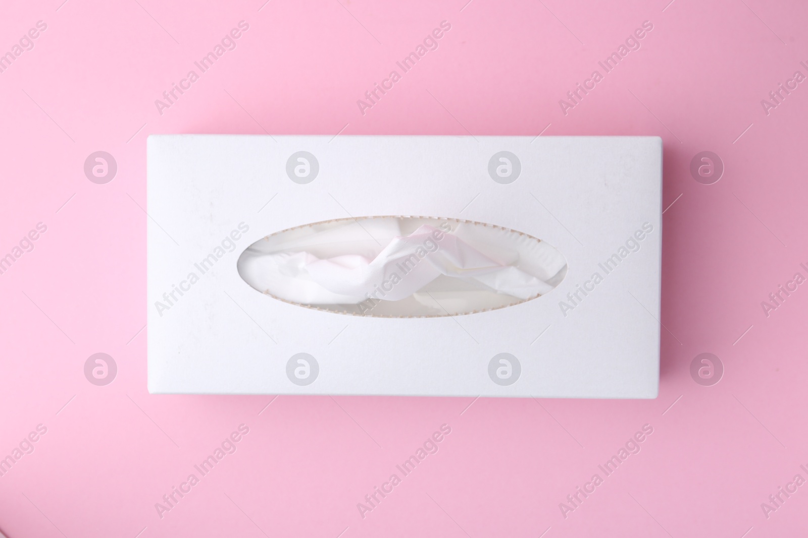Box with paper handkerchiefs on pink background, top view Photo of Box with paper handkerchiefs on pink background, top view