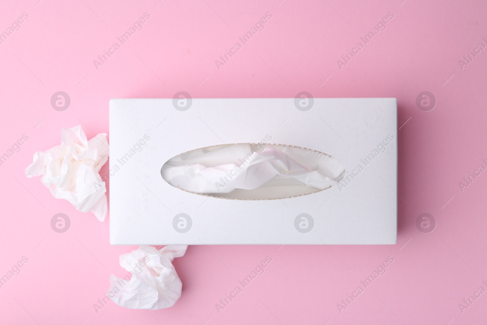 Box with paper handkerchiefs and crumpled tissues on pink background, flat lay Photo of Box with paper handkerchiefs and crumpled tissues on pink background, flat lay