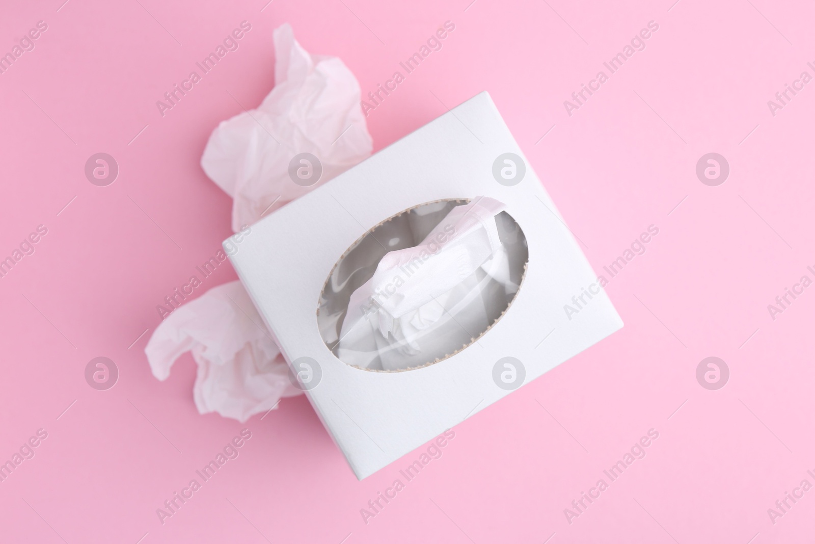 Box with paper handkerchiefs and crumpled tissues on pink background, flat lay Photo of Box with paper handkerchiefs and crumpled tissues on pink background, flat lay