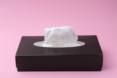 Photo of Box with paper handkerchiefs on pink background, closeup