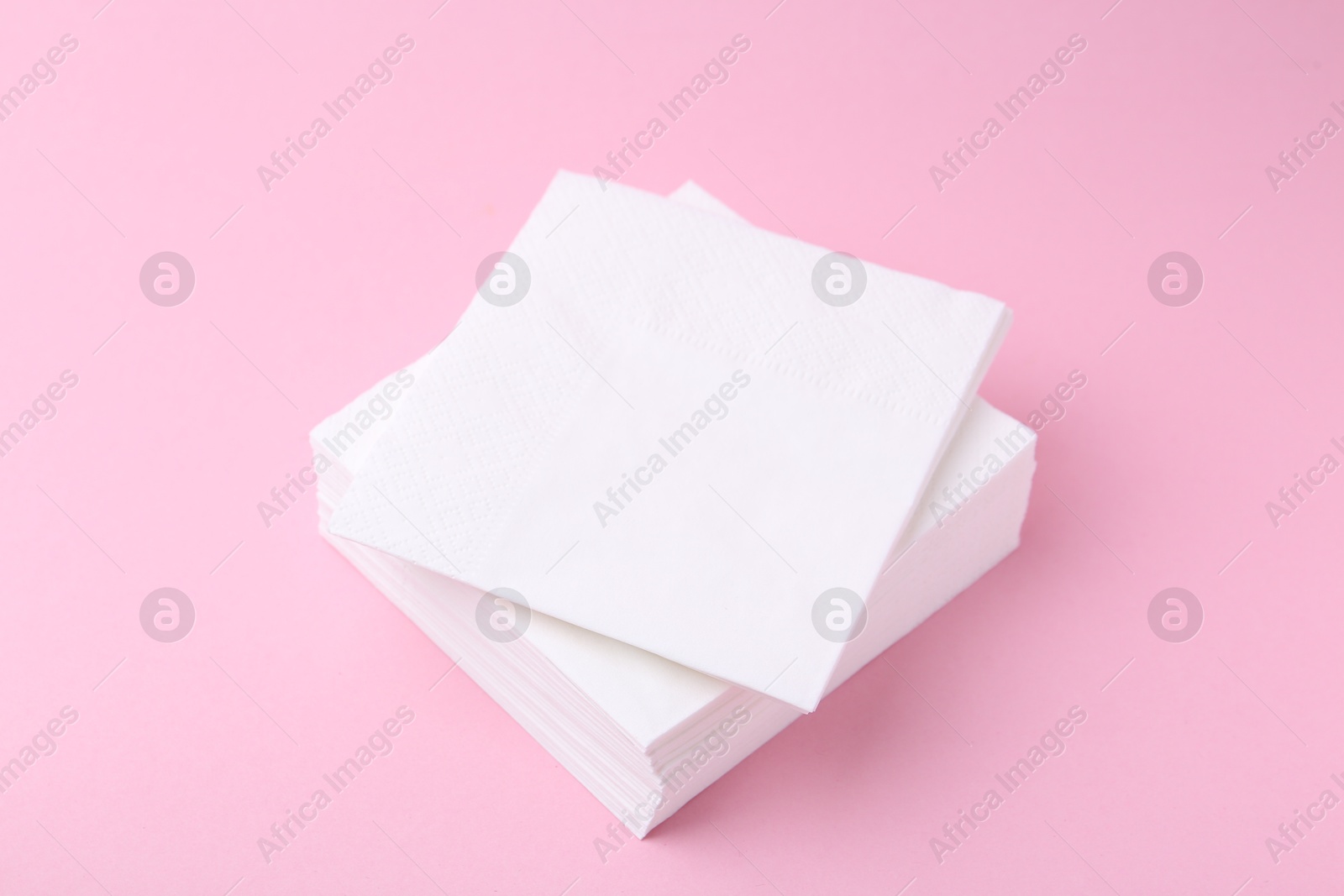 Stack of white handkerchiefs on pink background, closeup Photo of Stack of white handkerchiefs on pink background, closeup