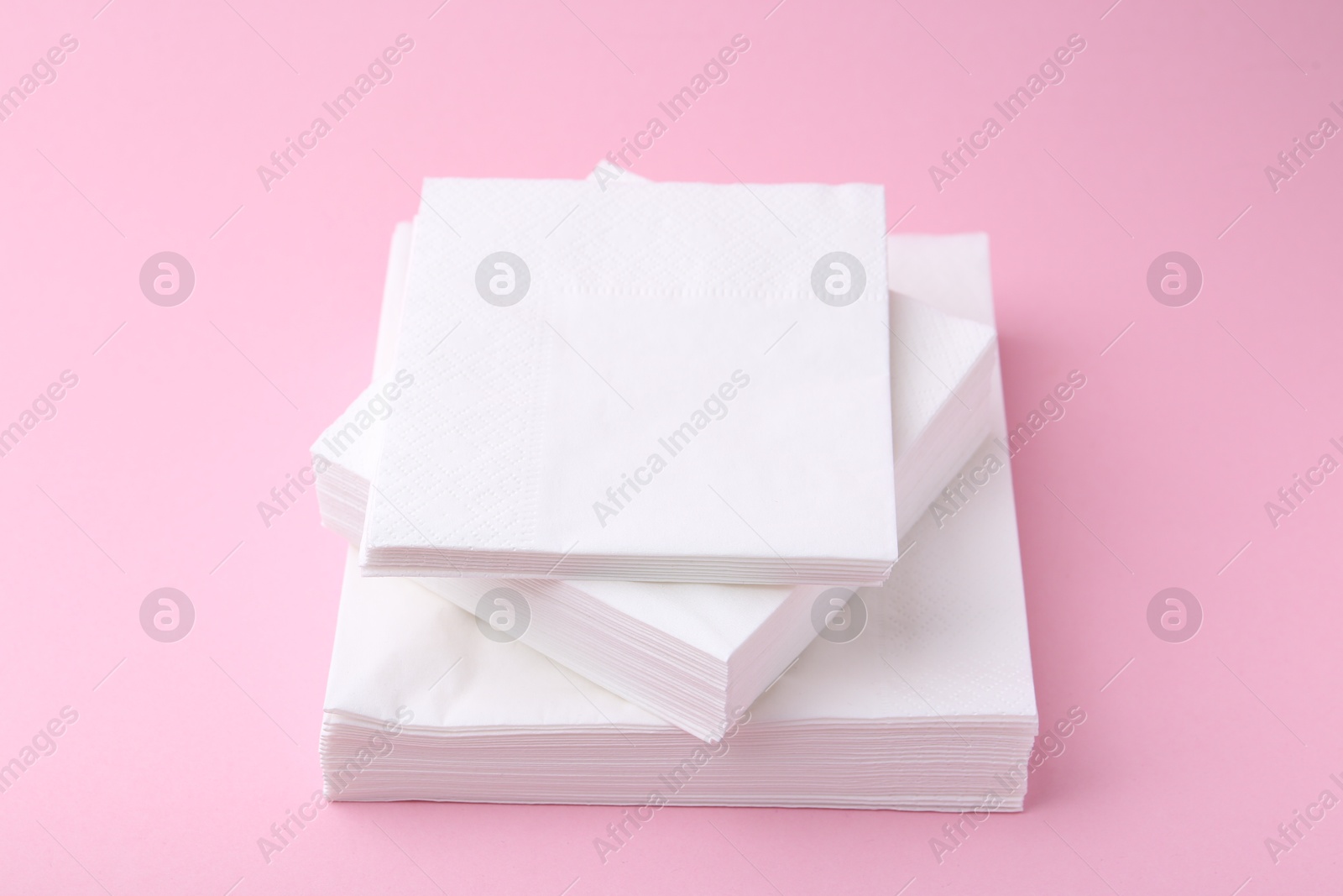 Stack of white handkerchiefs on pink background, closeup Photo of Stack of white handkerchiefs on pink background, closeup