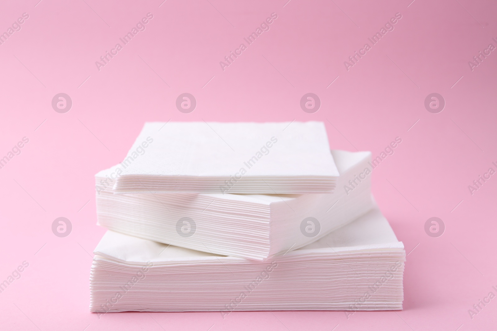 Stack of white handkerchiefs on pink background, closeup Photo of Stack of white handkerchiefs on pink background, closeup