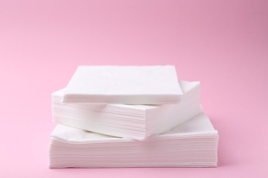 Photo of Stack of white handkerchiefs on pink background, closeup