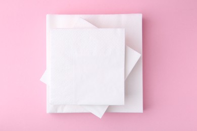 Photo of Stack of white handkerchiefs on pink background, top view