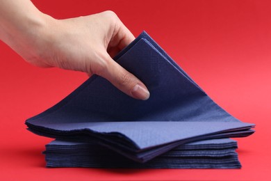 Photo of Woman with handkerchiefs on red background, closeup