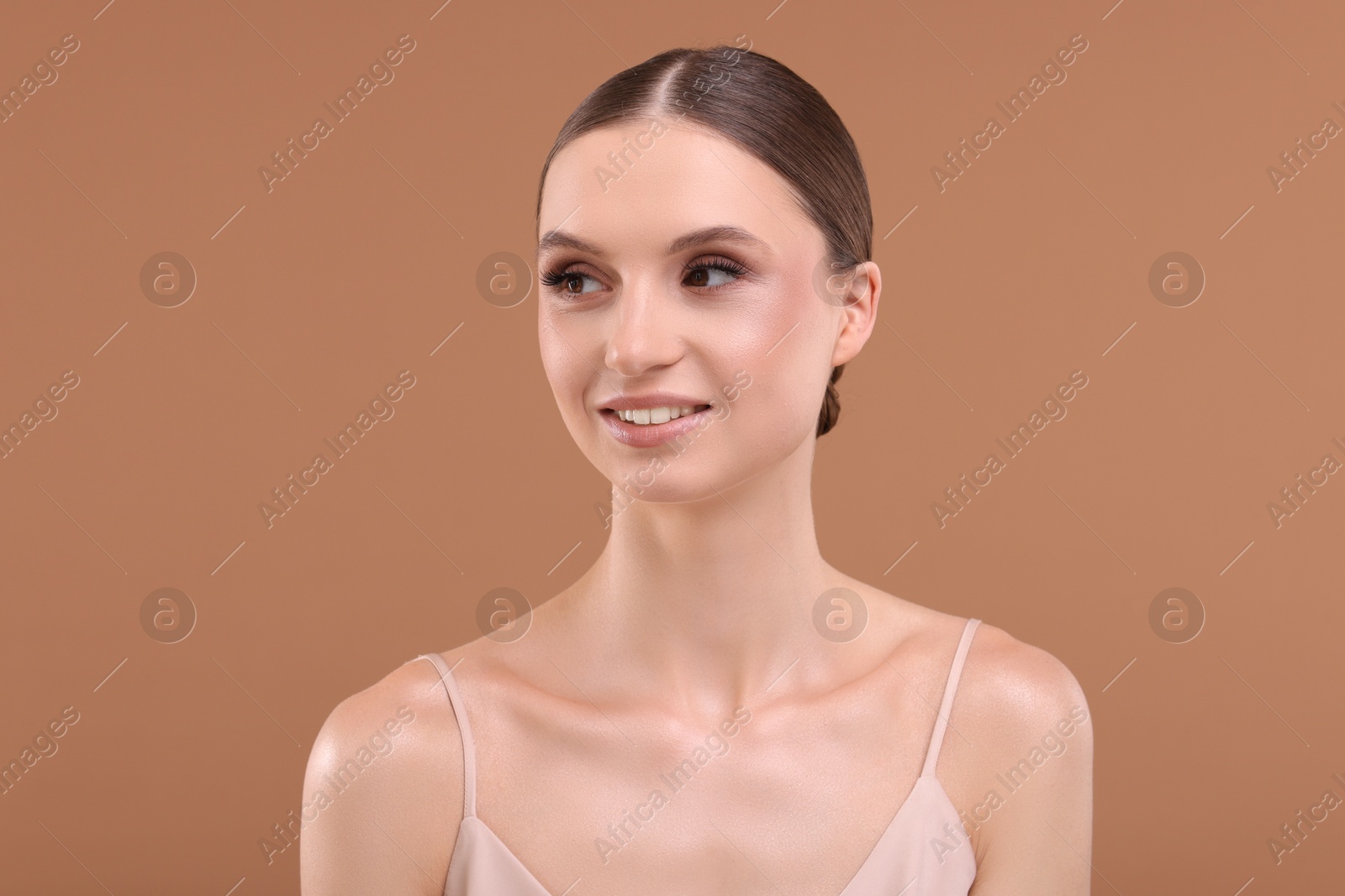 Portrait of beautiful young woman on beige background Photo of Portrait of beautiful young woman on beige background