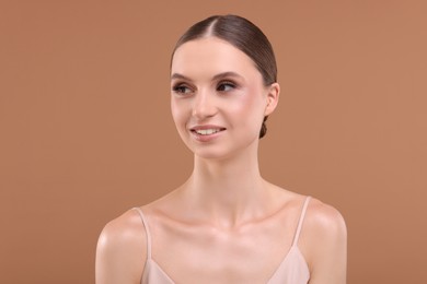 Photo of Portrait of beautiful young woman on beige background