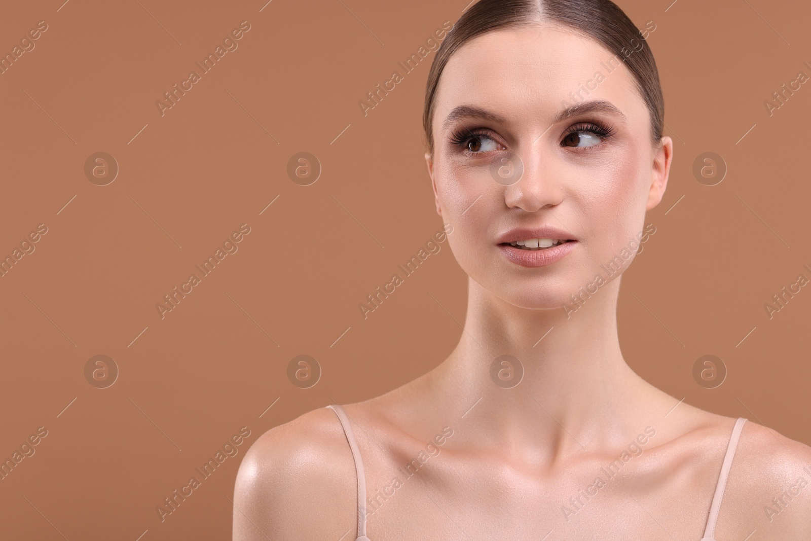 Portrait of beautiful young woman on beige background, space for text Photo of Portrait of beautiful young woman on beige background, space for text