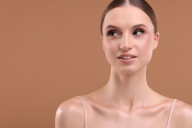 Photo of Portrait of beautiful young woman on beige background, space for text
