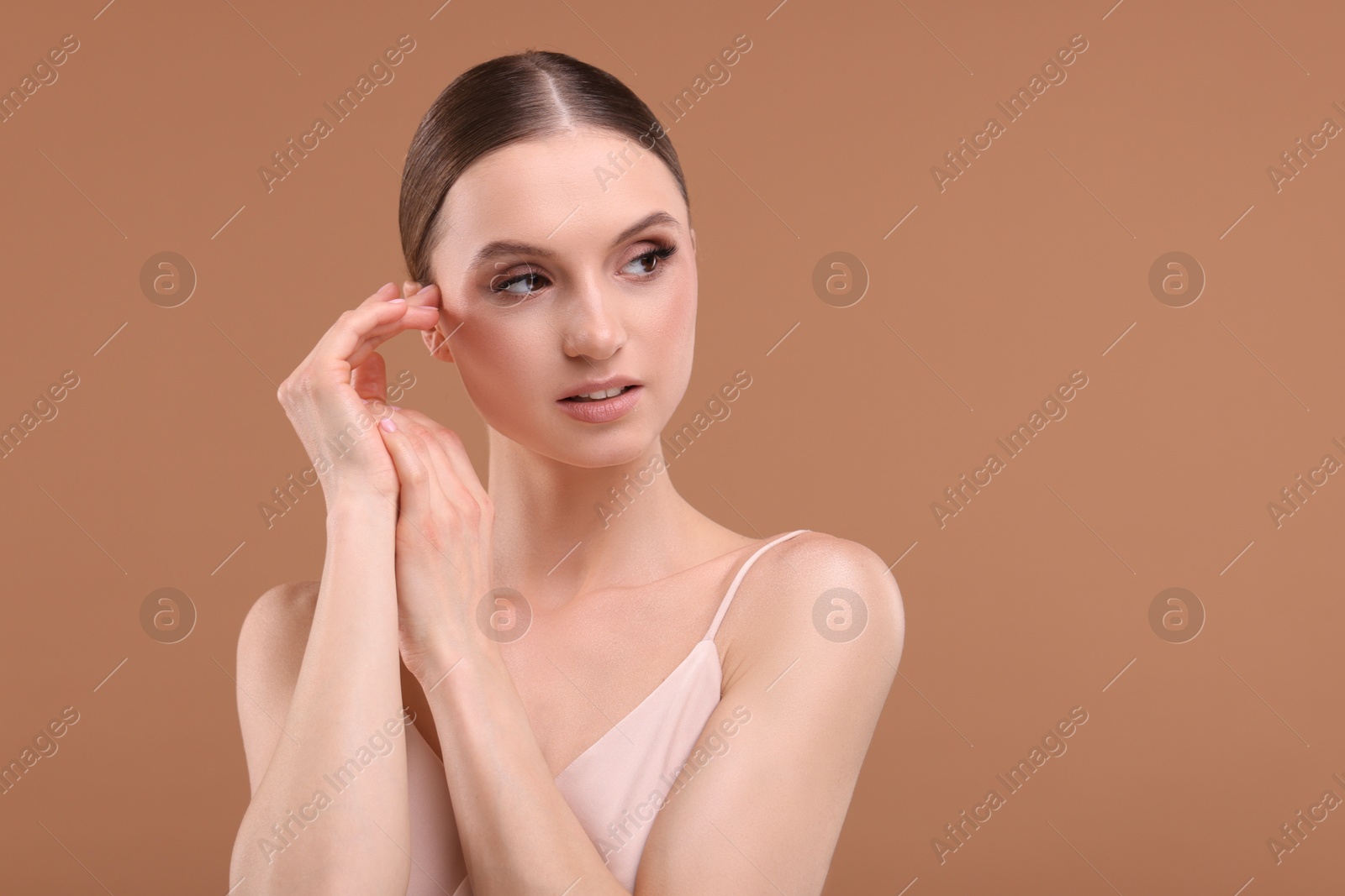 Portrait of beautiful young woman on beige background, space for text Photo of Portrait of beautiful young woman on beige background, space for text